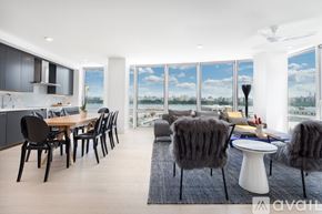 North Bergen condo for rent - A modern dining room with a view of the cityscape outside the large windows.