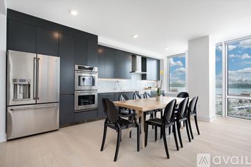 North Bergen condo for rent - A modern kitchen with a dining table and chairs.