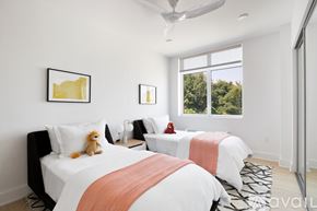 North Bergen condo for rent - A bedroom with two beds and a ceiling fan.