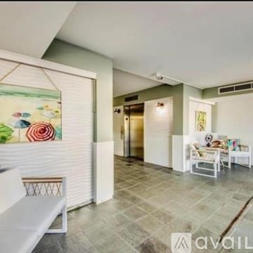 North Fort Myers condo for rent - A living room with a white sofa and a painting on the wall.