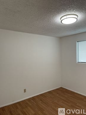 Lynnwood apartment for rent - A room with wooden flooring and a window with blinds.