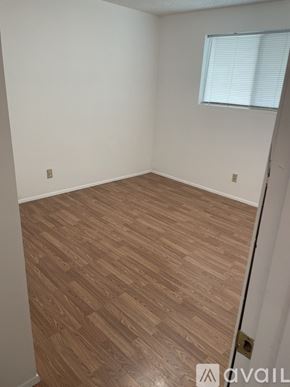 Lynnwood apartment for rent - A room with wooden flooring and a window with blinds.
