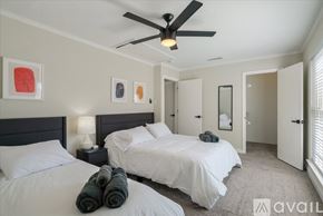 Richardson house for rent - A bedroom with two beds and a ceiling fan.