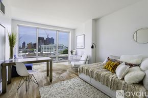 Queens apartment for rent - A bedroom with a large bed and a desk with a chair.