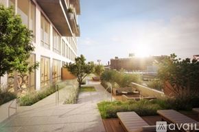 Queens apartment for rent - A sunny day at the outdoor seating area of a modern building.