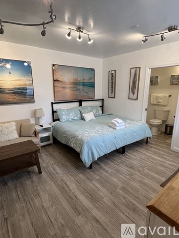 Marina apartment for rent - A kitchen with white cabinets and a wooden island.