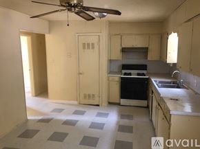 North Little Rock house for rent - A kitchen with a fan and a checkered floor.