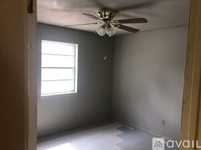 North Little Rock house for rent - A room with a ceiling fan and a window.