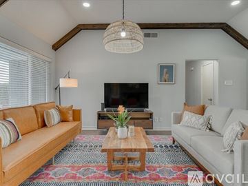 Garland house for rent - A living room with a wooden coffee table and two couches.
