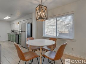 Garland house for rent - A modern kitchen with a table and chairs.