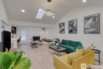 North Richland Hills house for rent - A living room with a yellow couch and a fireplace.