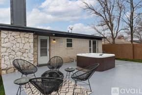 North Richland Hills house for rent - A patio with a hot tub and chairs is available for rent.