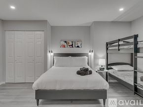 Garland house for rent - A bedroom with a large bed and a bunk bed.