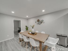 Garland house for rent - A dining room with a wooden table and white chairs.