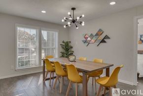 Plano house for rent - A dining room with a wooden table and yellow chairs.