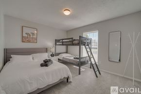Plano house for rent - A bedroom with a white bed and a bunk bed with a ladder.