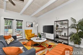 Irving house for rent - A modern dining room with a long table and orange chairs.
