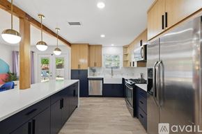 Dallas house for rent - A modern kitchen with wooden cabinets and stainless steel appliances.