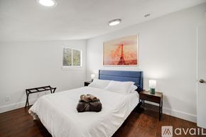 Grand Prairie house for rent - A bedroom with a large bed and a painting on the wall.