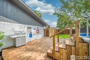 Grand Prairie house for rent - A wooden deck with a staircase leading to a pool area.