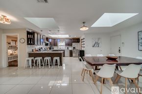 Plano house for rent - A modern kitchen with a dining table and chairs.