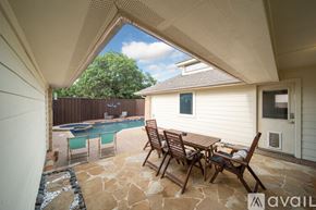 Plano house for rent - A patio with a table and chairs overlooking a pool.