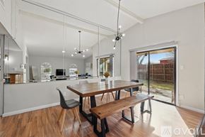 Carrollton house for rent - A modern dining room with a wooden table and bench.