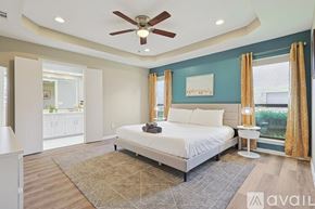 Allen house for rent - A bedroom with a large bed and a ceiling fan.