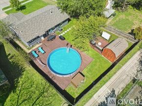 Richardson house for rent - An aerial view of a house with a blue pool in the backyard.