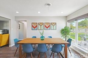 Richardson house for rent - A dining room with a wooden table and blue chairs.