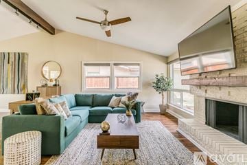 Dallas house for rent - A living room with a green couch and a wooden coffee table.