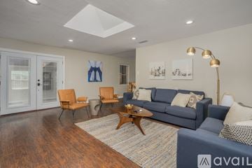 Dallas house for rent - A living room with a blue couch and a coffee table.
