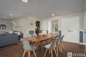 Dallas house for rent - A modern dining room with a wooden table and grey chairs.