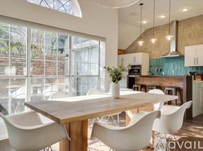 Dallas house for rent - A dining area with a wooden table and white chairs.