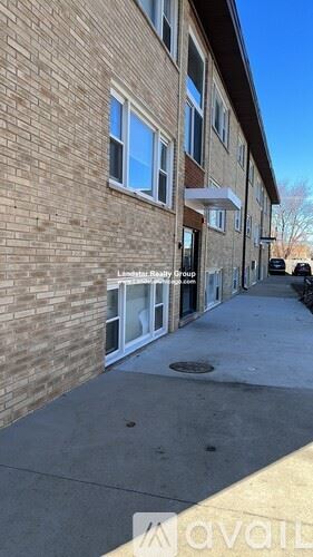 Schiller Park apartment for rent - A building with a sign that says "Liberty Realty Group" on it.