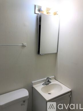 Seattle apartment for rent - A small bathroom with a toilet, sink and mirror.