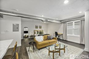 Grand Rapids apartment for rent - A living room with a sofa, a coffee table, and a dining table.