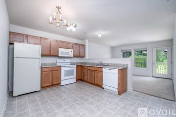 Mountville apartment for rent - A kitchen with white appliances and wooden cabinets.
