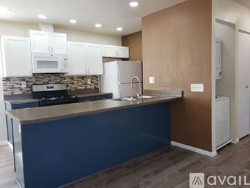 El Cajon apartment for rent - A kitchen with white appliances and cabinets is on the market.