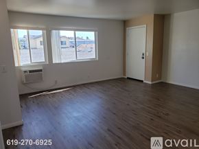 El Cajon apartment for rent - A kitchen with white cabinets and a countertop with a microwave and oven.