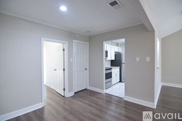 Temple apartment for rent - A kitchen with a black fridge and stove top oven.