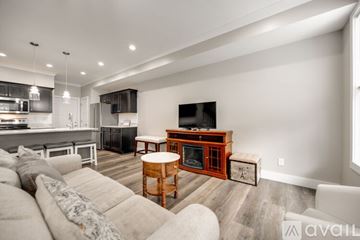 Cleveland apartment for rent - A modern living room with a white sofa and a wooden coffee table.