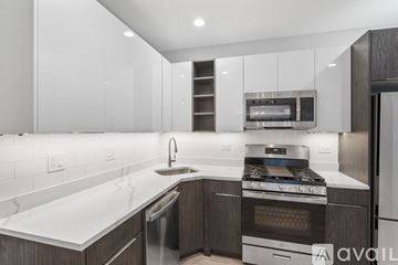 Chicago apartment for rent - A modern kitchen with a stainless steel oven and a white countertop.