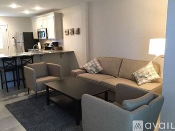 Ruston apartment for rent - A modern living room with a grey couch and a black coffee table.