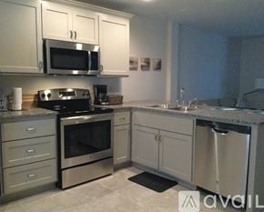 Ruston apartment for rent - A kitchen with a stove top oven, microwave, and dishwasher.