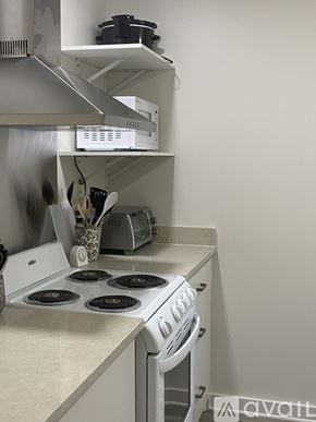Ruston house for rent - A white stove with a pot on it.