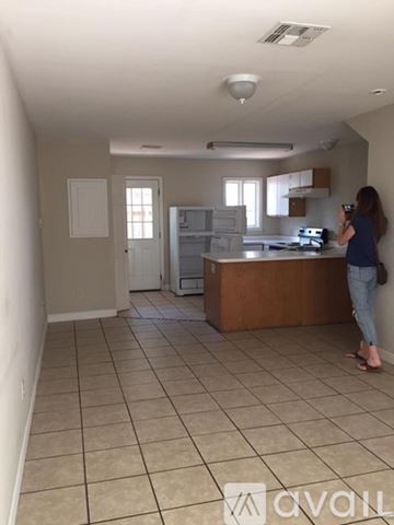 Ruston townhouse for rent - A woman is standing in a kitchen with a counter and cabinets.