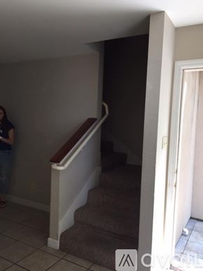 Ruston townhouse for rent - A woman stands in a hallway with a staircase.