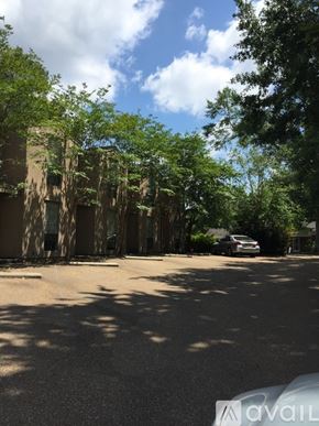 Ruston townhouse for rent - A tree-lined street with a car parked on the side.