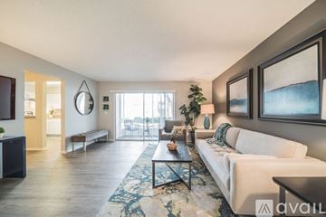 Clearwater apartment for rent - A living room with a white couch and a rug.